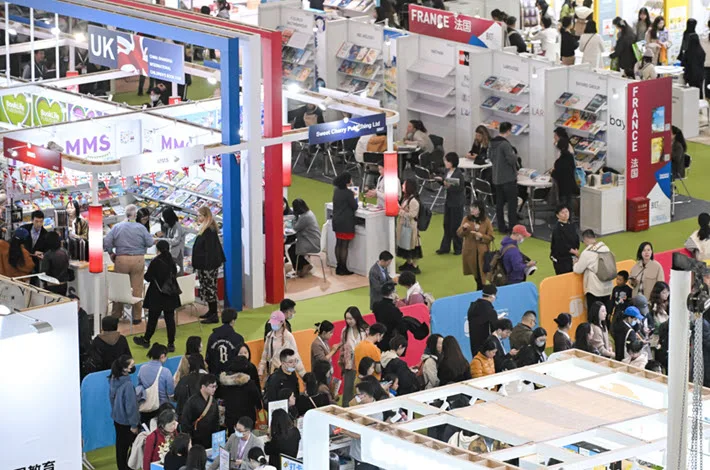 People Interacting And Networking At A Book Fair In China, Representing Collaboration Between Publishers