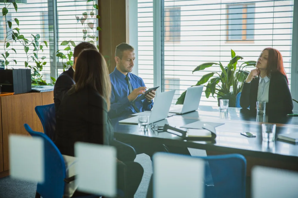 A Photo Of A Small Press Team Meeting With A Client, Discussing Book Printing Options And Providing Expert Advice.