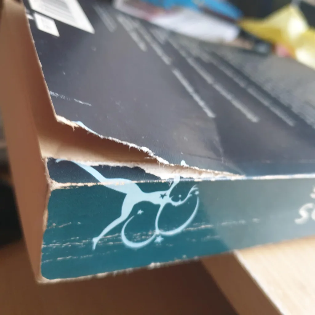 damaged book with a torn cover