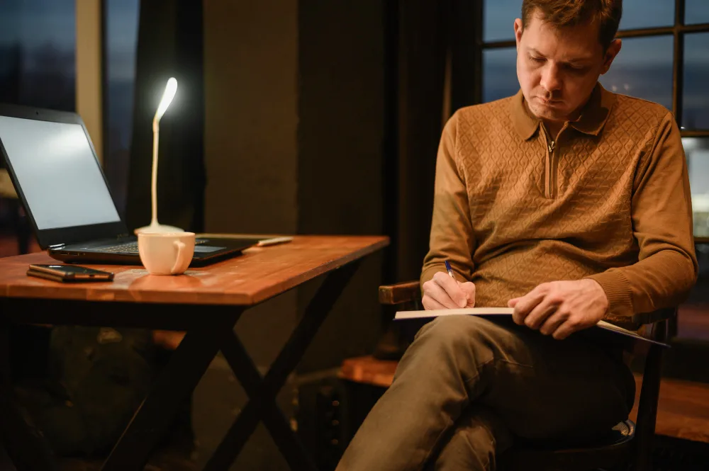 An Author Working Diligently At Their Desk